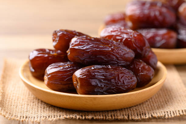 date palm fruit (medjool) on wooden plate